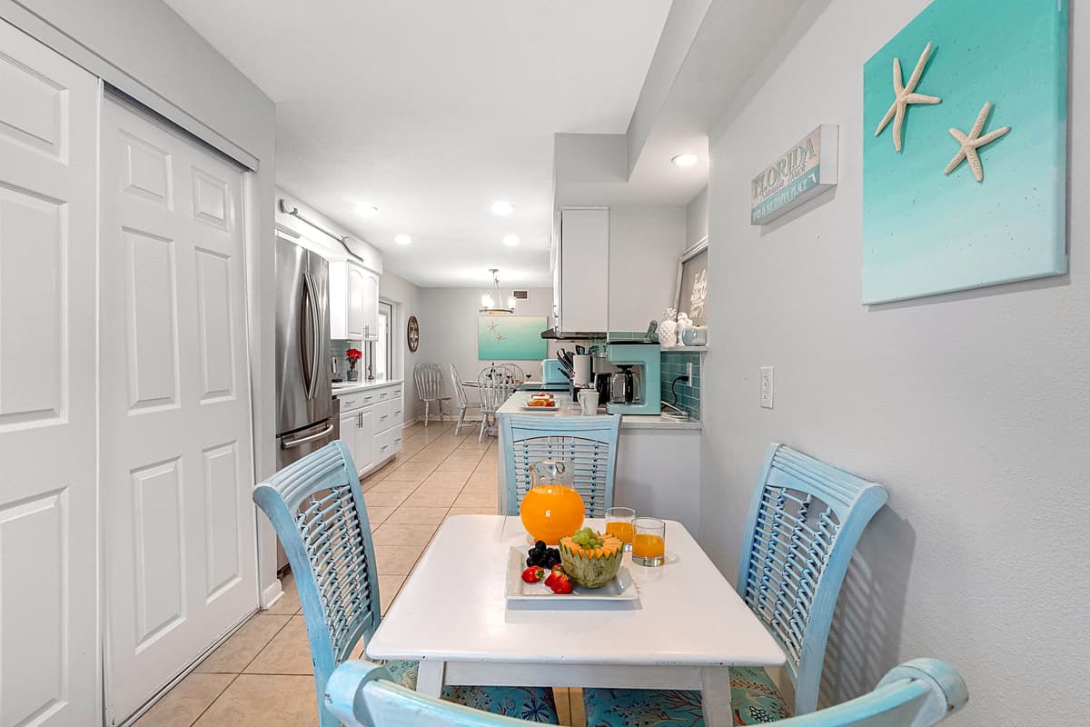 A second dining area offers a cozy four-seater dining table, ideal for more intimate meals or casual dining.