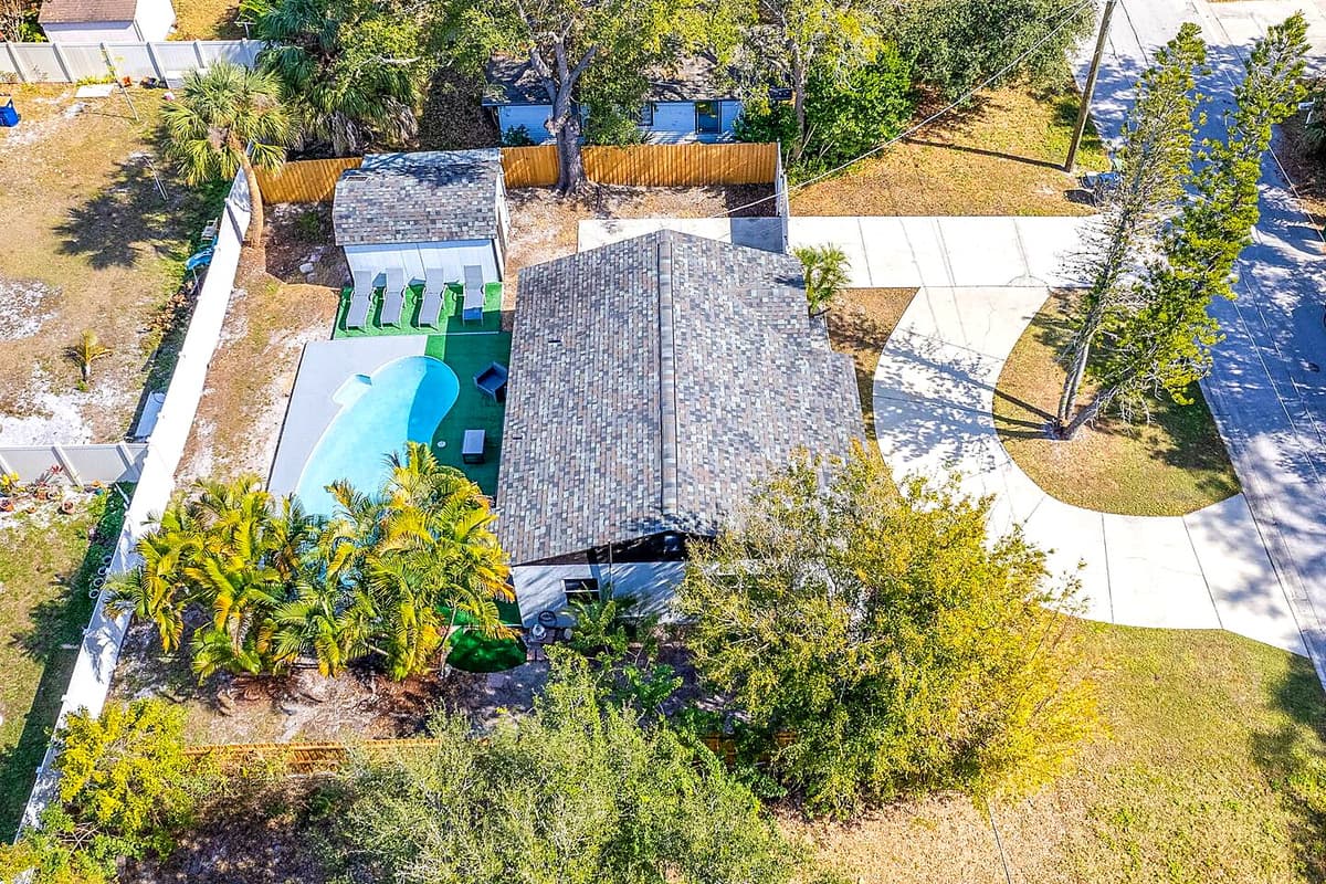 Aerial side view of this lovely property! Worry not about kids playing in the fully fenced backyard during your stay! Inquire about this property now!