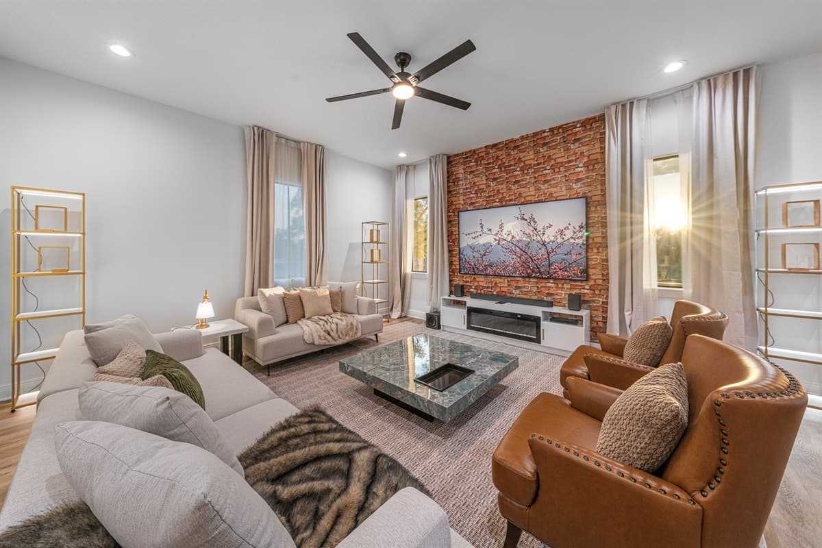 Cozy living area with comfortable seating, warm decor, and a sleek entertainment setup for movie nights.