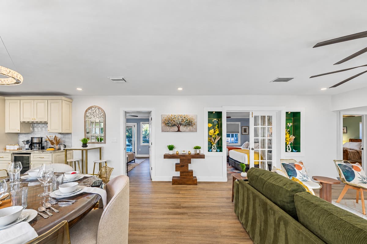 Enjoy gathering in this sun-filled living room, complete with a comfortable sectional, stylish coffee tables, and a warm, welcoming vibe.