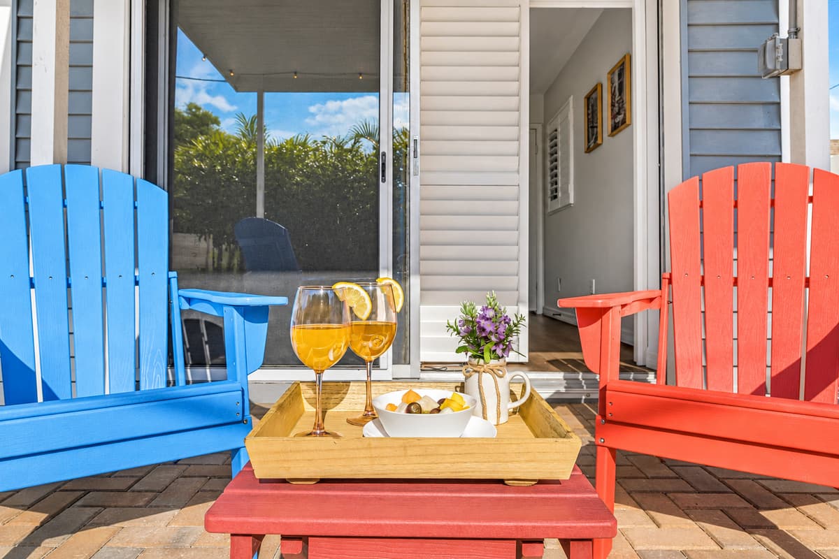 Close-up of outdoor seating with decorative setup—perfect for enjoying drinks and conversation 
Food and drinks shown are for staging purposes only and are not included.