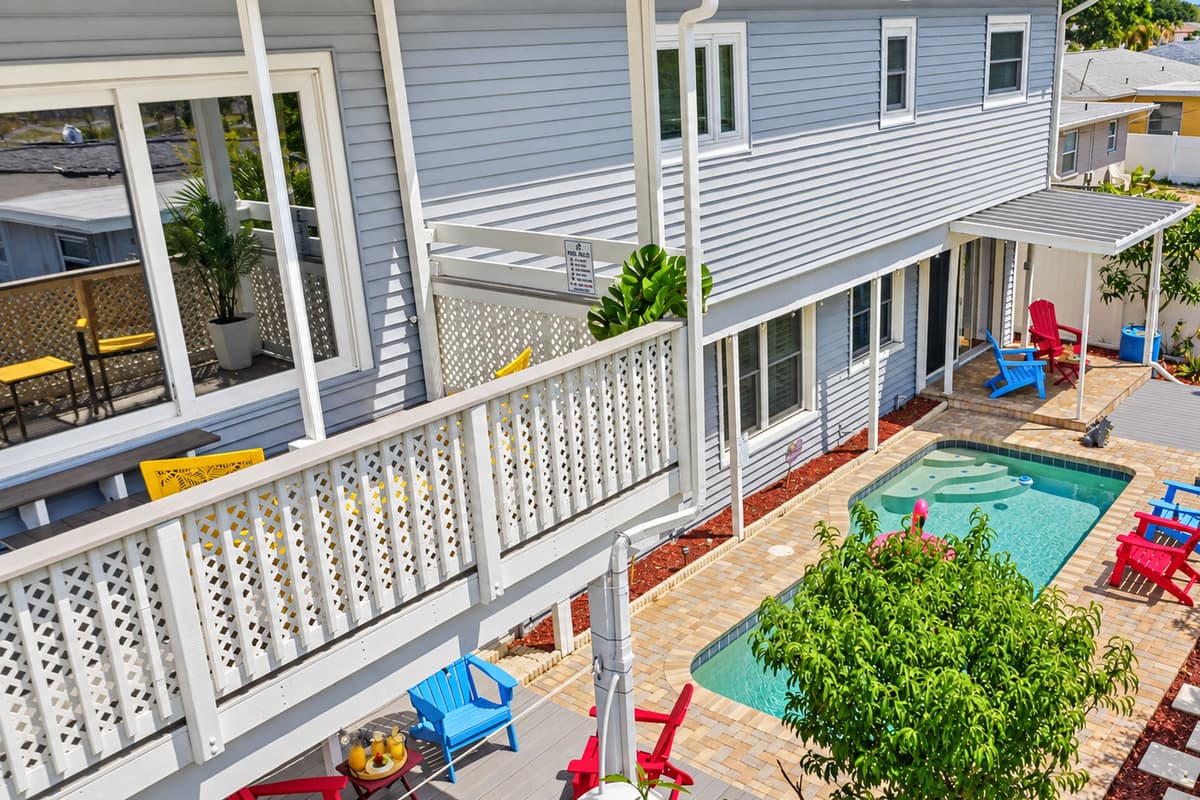 Elevated view of the backyard showcasing the pool, seating areas, and home exterior—ideal for group gatherings 
