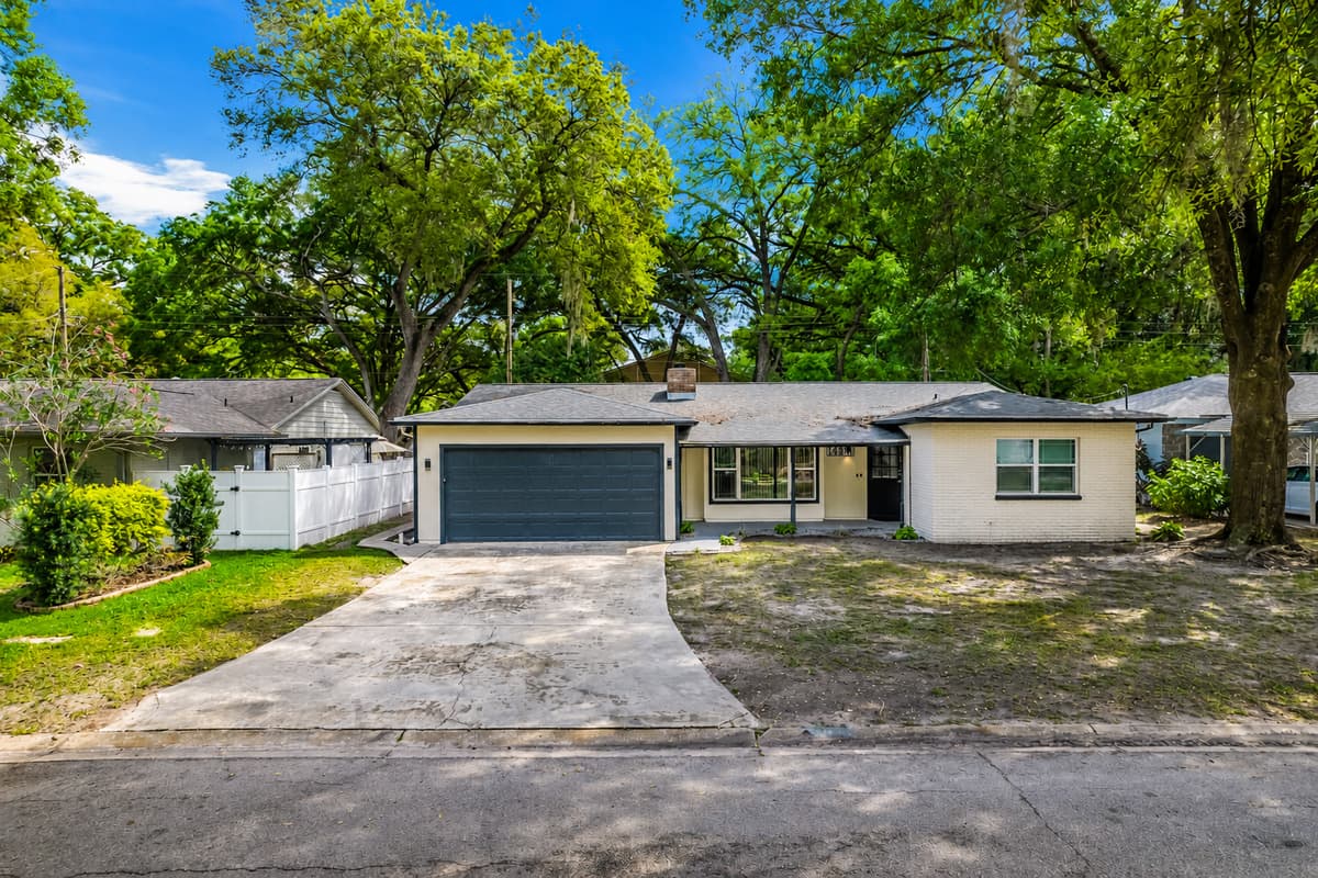 The stunning front side view of the house showcasing our magnificent front yard, amazing tree, and driveway. If you are interested in this property, don't hesitate to send us a message!