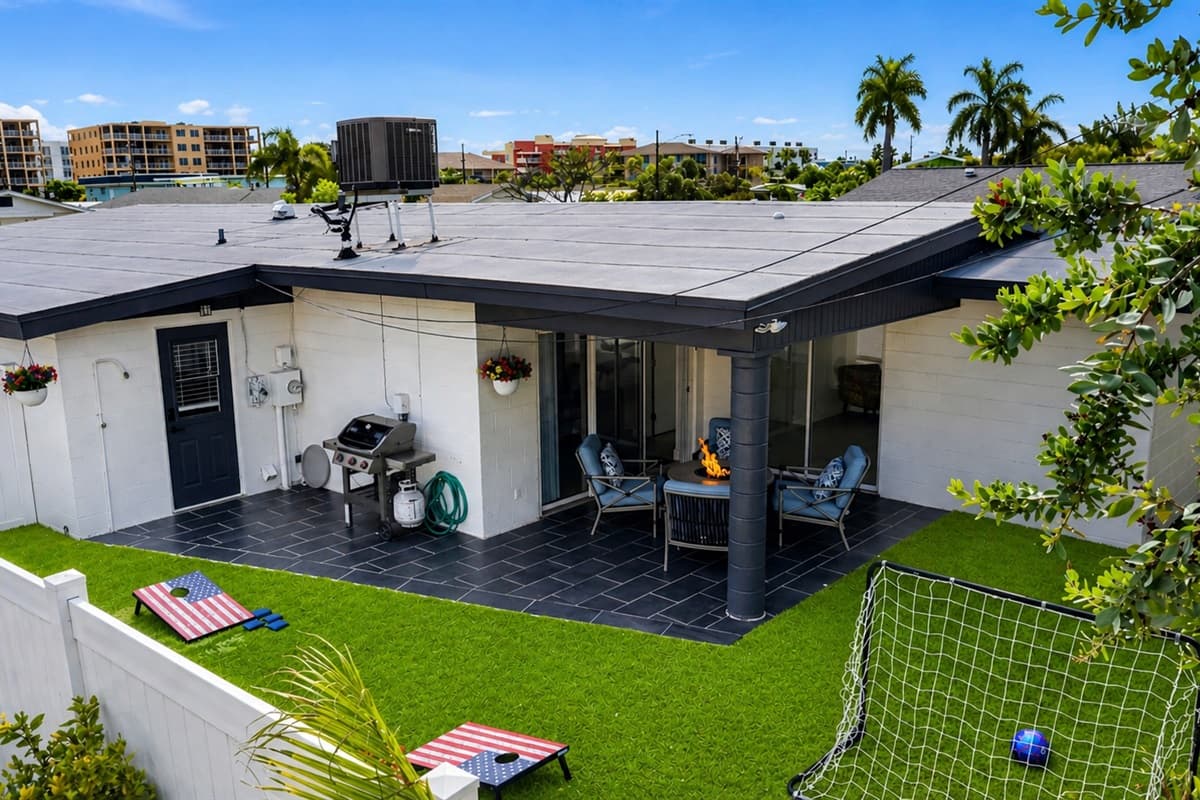 Aerial backyard view showcasing the private outdoor entertainment space and lawn games.