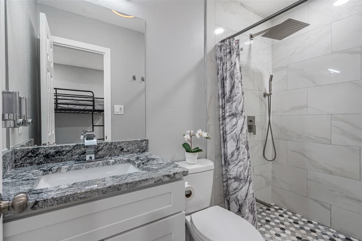 Feel refreshed in this stunning bathroom with sink, toilet, and walk-in shower.  Enjoy a relaxing shower after a long day of travel from your home to your home away from home. If you like this property, send us a message now!