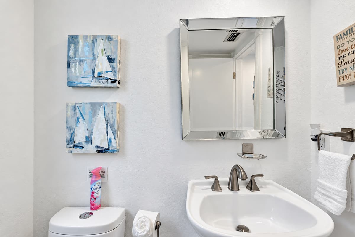 To enhance the functionality of this half bathroom, soft, ambient lighting has been installed, offering just the right amount of illumination without being overpowering.