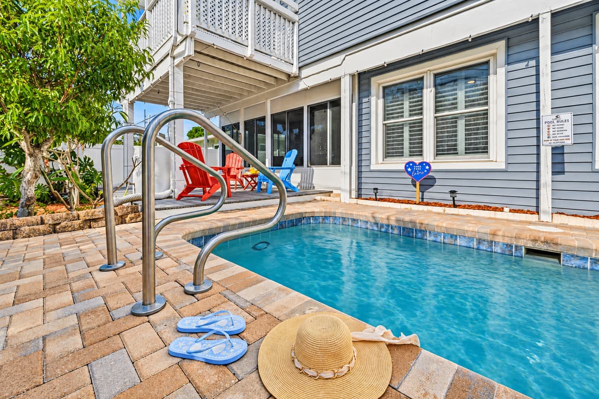 Private backyard pool area with lounge seating—your own tropical oasis for cooling off and soaking up the sun 