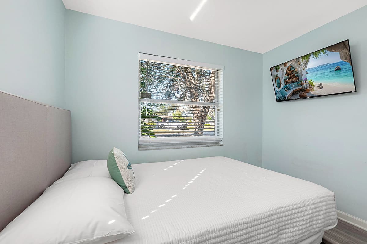 This generously sized room features two plush double beds, providing ample sleeping space for multiple guests.