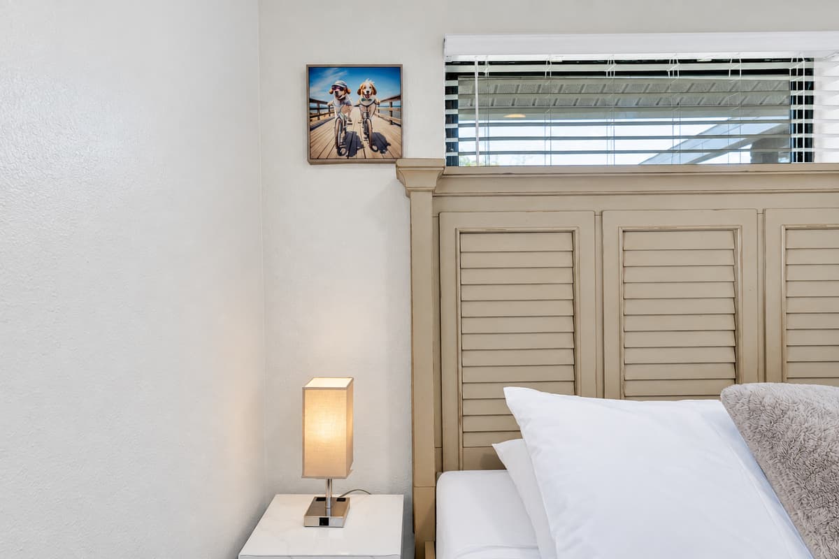 Louvered closet doors, a bedside lamp low enough to read by, and a corner that stays quiet while the rest of the house is still awake. Small things, but they're the difference between sleeping somewhere and actually resting there.