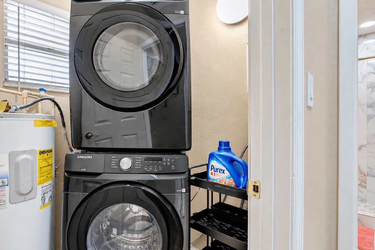 The laundry area boasts a modern washer and dryer, accompanied by a comprehensive selection of laundry supplies to make your chores a breeze.
