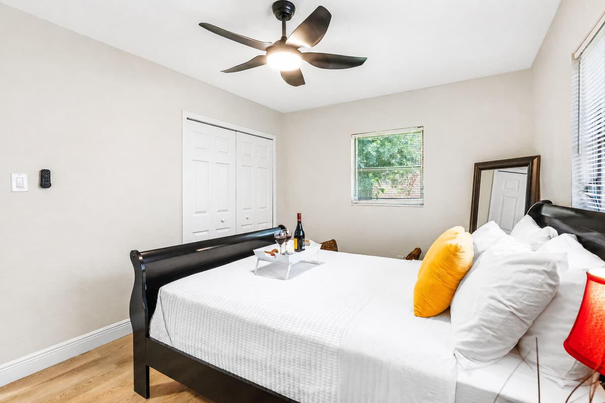 A modern ceiling fan with wide, sculpted blades and integrated lighting ensures the room stays cool, fresh, and well-lit throughout your stay.
