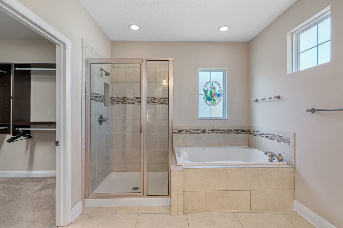 Spacious bathroom equipped with a jetted bathtub, sink, toilet and shower. Enjoy a relaxing bath after a long day of travel from your home to your home away from home. If you think this property if for you, send us an inquiry right away!