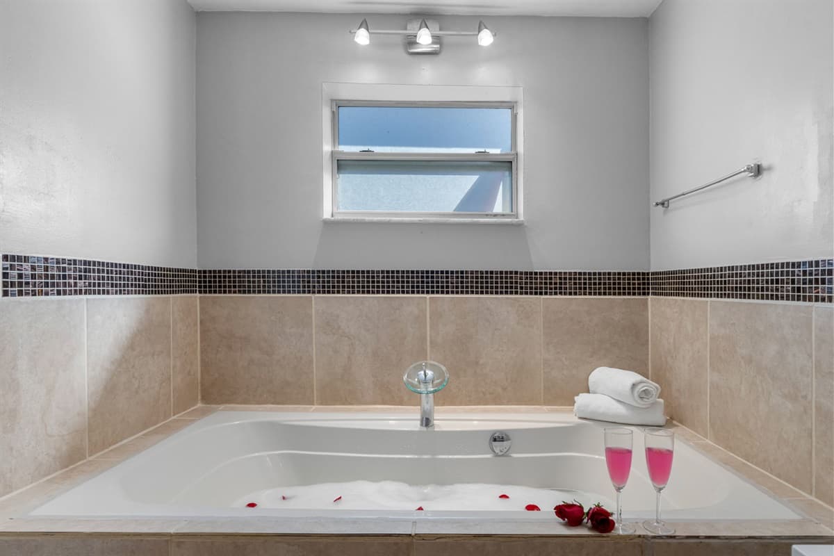 Relax and recharge in the ensuite’s deep tub — the perfect post-beach treat.