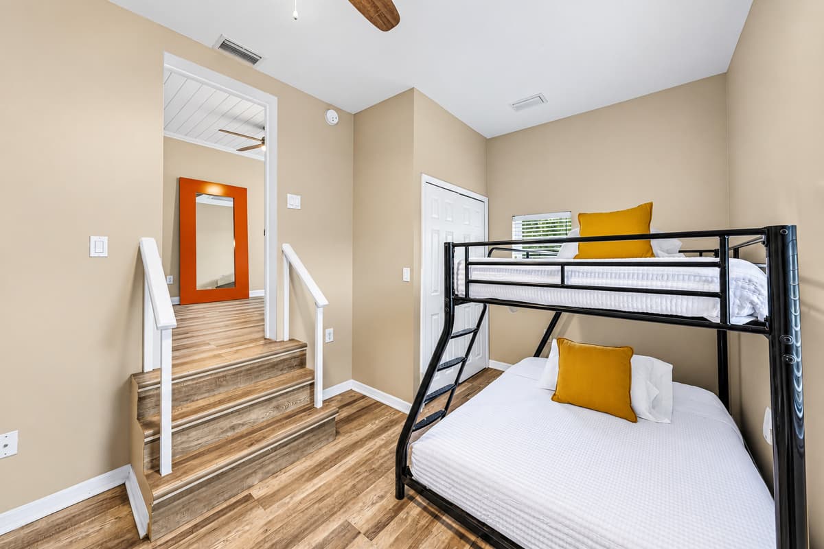 Bunk room with comfortable beds and nearby stair access—great for families or group stays.