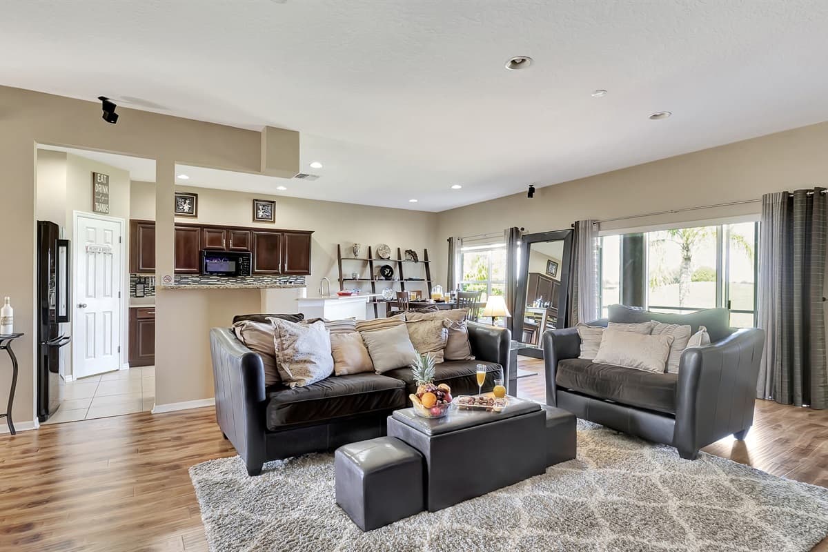 Step into luxury with our spacious living room boasting a massive, cloud-like grey sofa that practically begs you to sink in.