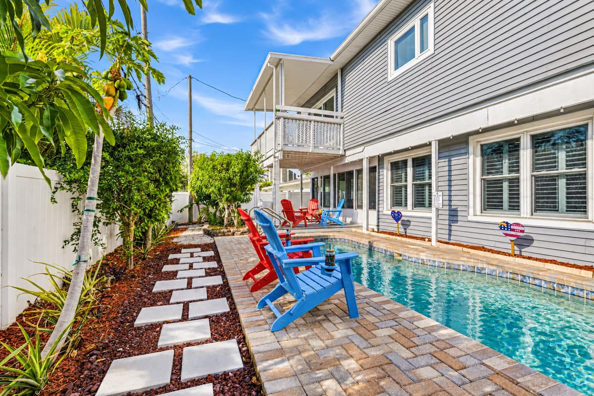 Charming backyard walkway with greenery leading to the pool area—adds a peaceful garden feel 