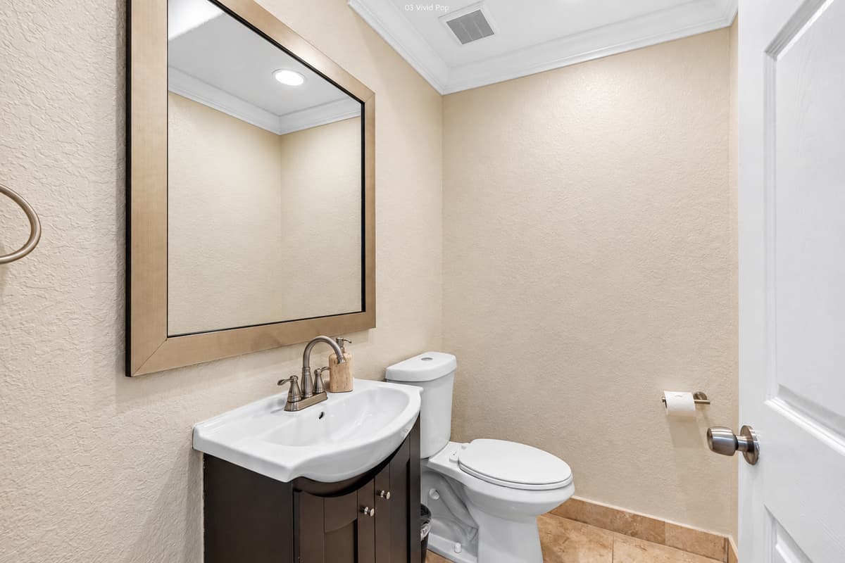 Perfect for quick visits or guest use, this half bath includes a toilet and vanity with sink, providing convenient access without compromising on style.