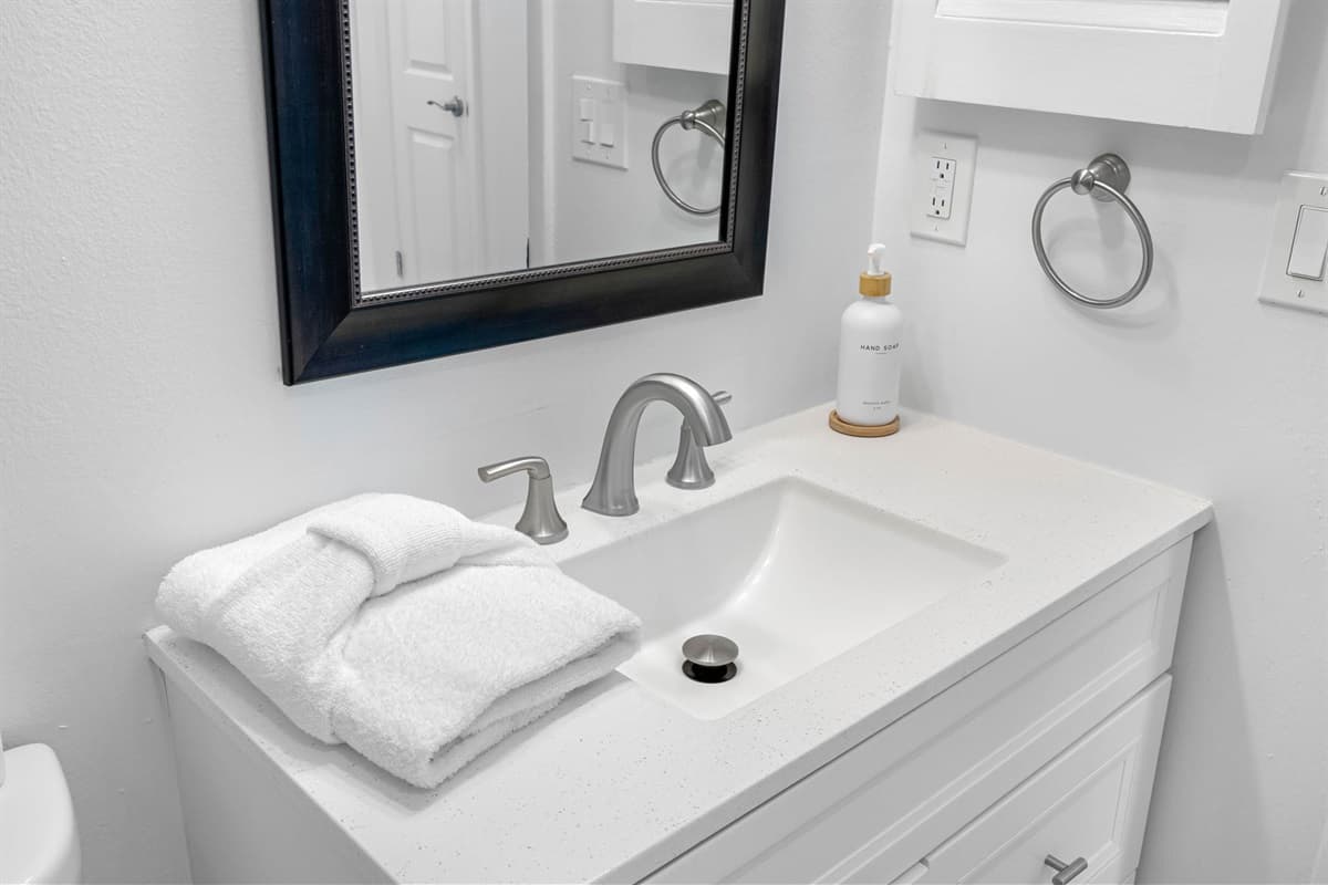 Ideal for families, this bathroom offers a bathtub for little ones and a shower for convenience.