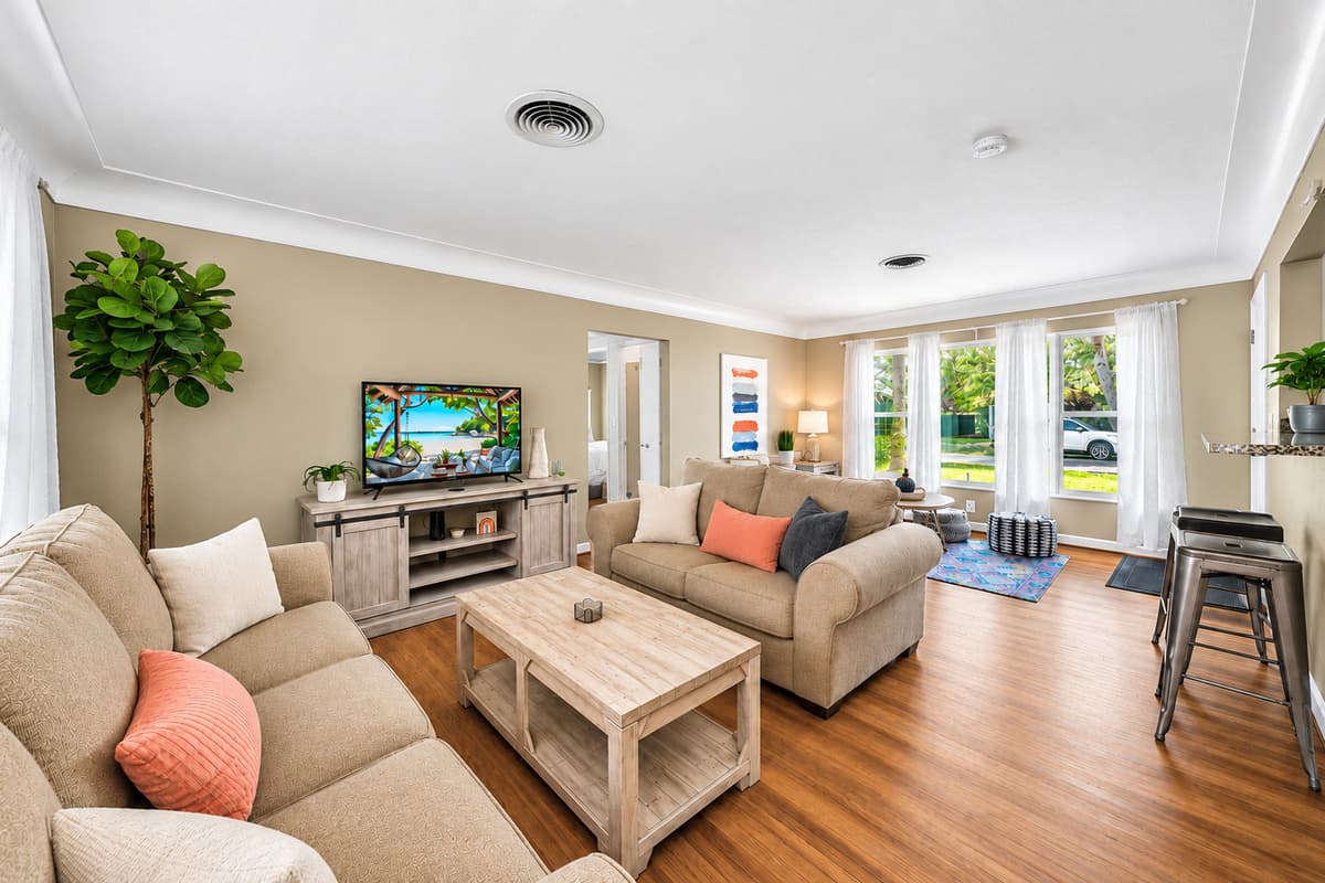 Wide living room view showcasing ample seating and an airy, open layout perfect for gatherings.