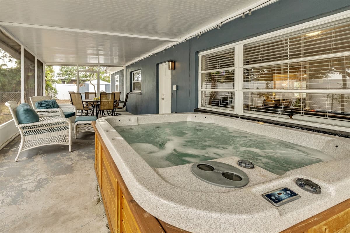 At the heart of this al fresco paradise lies the pièce de résistance—a bubbling hot tub that invites you into a symphony of relaxation.