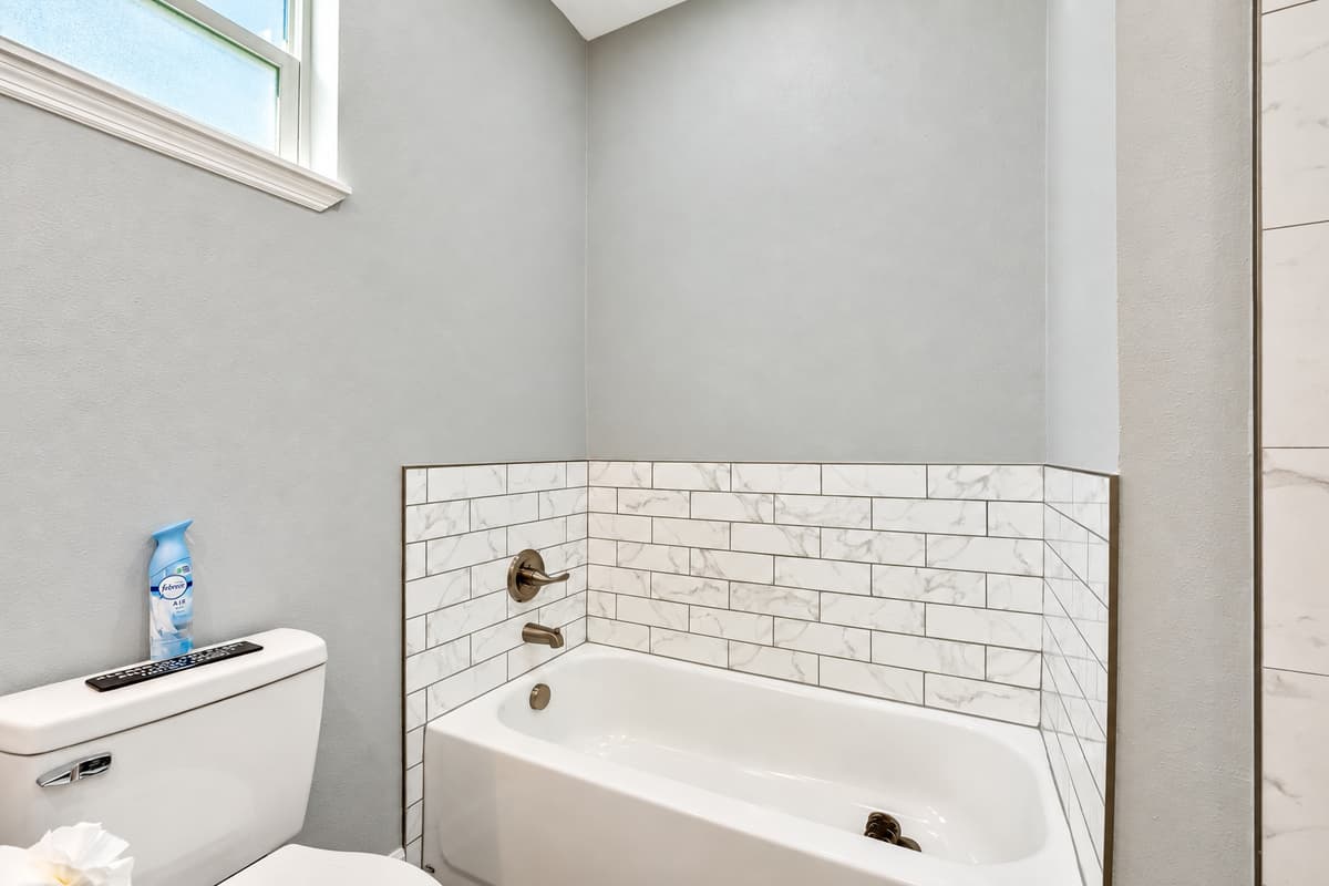 Sink into the soothing depths of the bathtub, where warm water envelops you in a cocoon of tranquility.