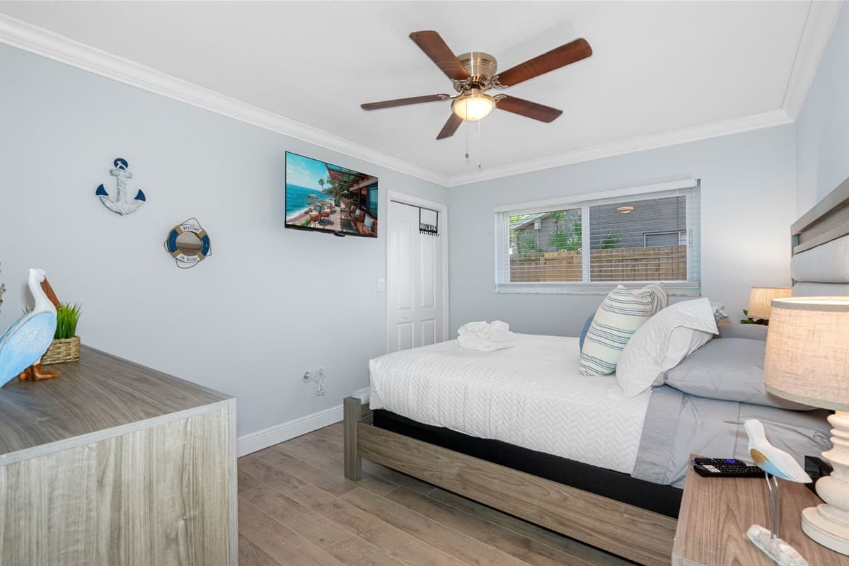 With its combination of cozy comfort and modern amenities, this bedroom offers a serene and inviting environment for a truly pleasant stay.