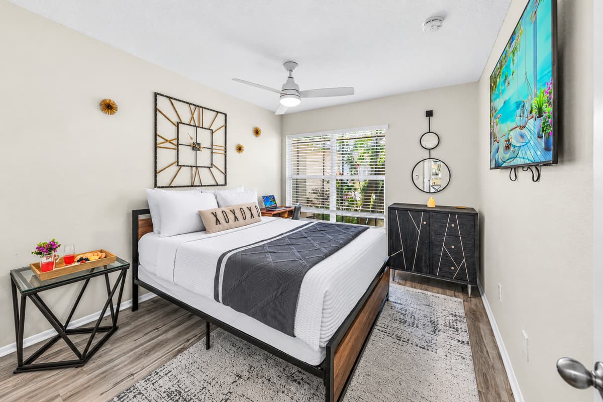 Comfortable guest bedroom with a queen bed, Smart TV, and plenty of natural light.