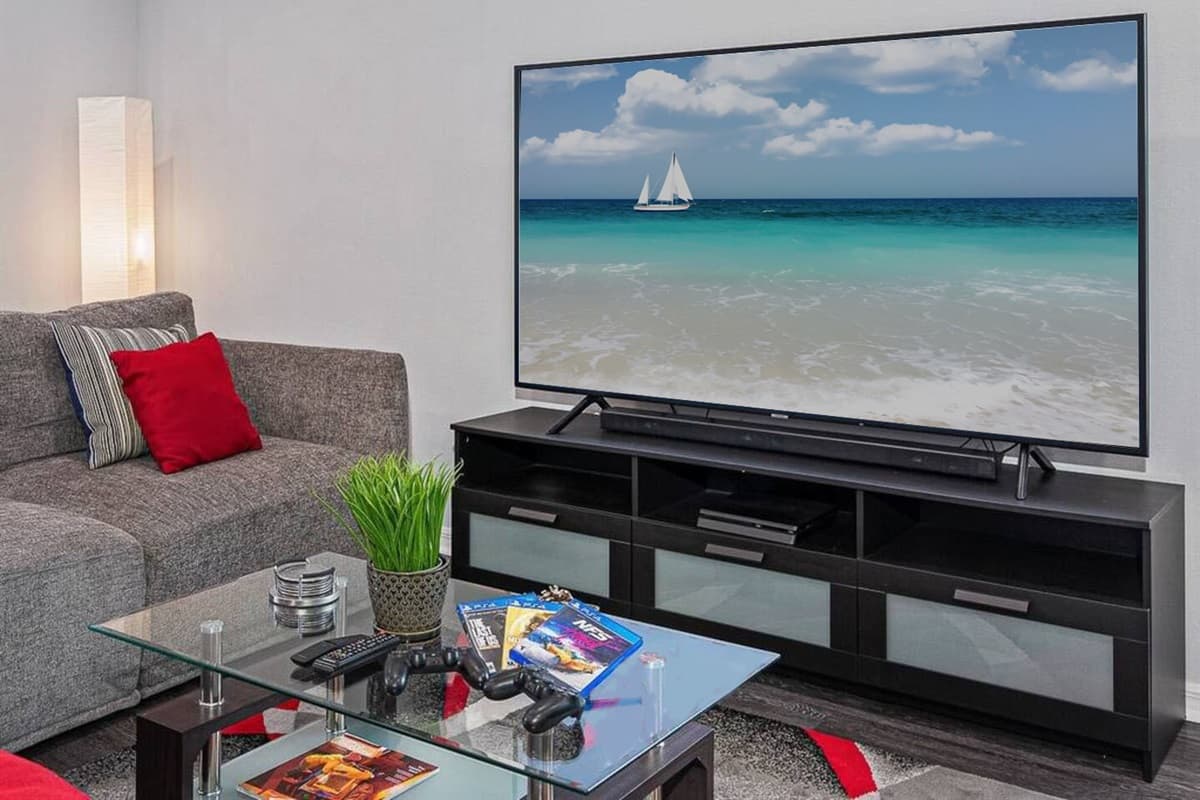 Adjacent to the couch, a smart TV takes center stage, offering a world of entertainment at your fingertips.