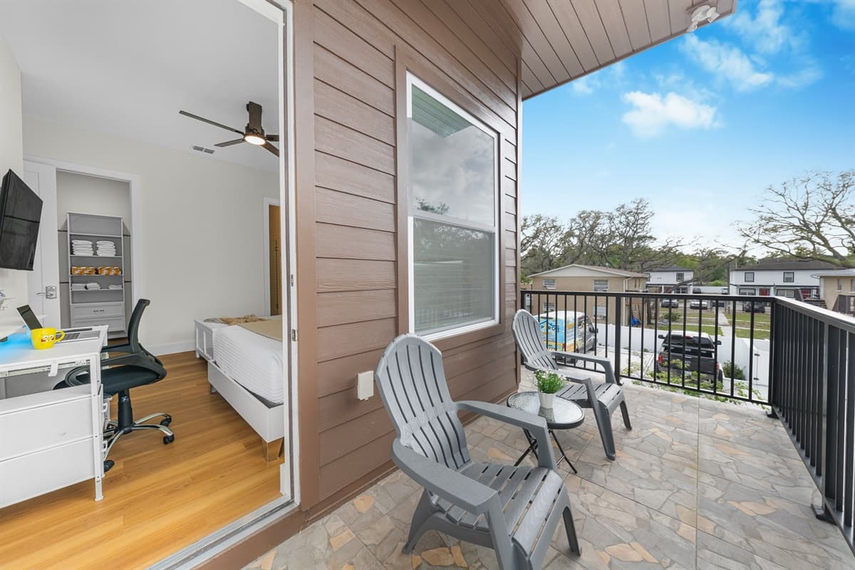 Private balcony with seating, offering a peaceful outdoor space to relax and enjoy fresh air just off the bedroom.