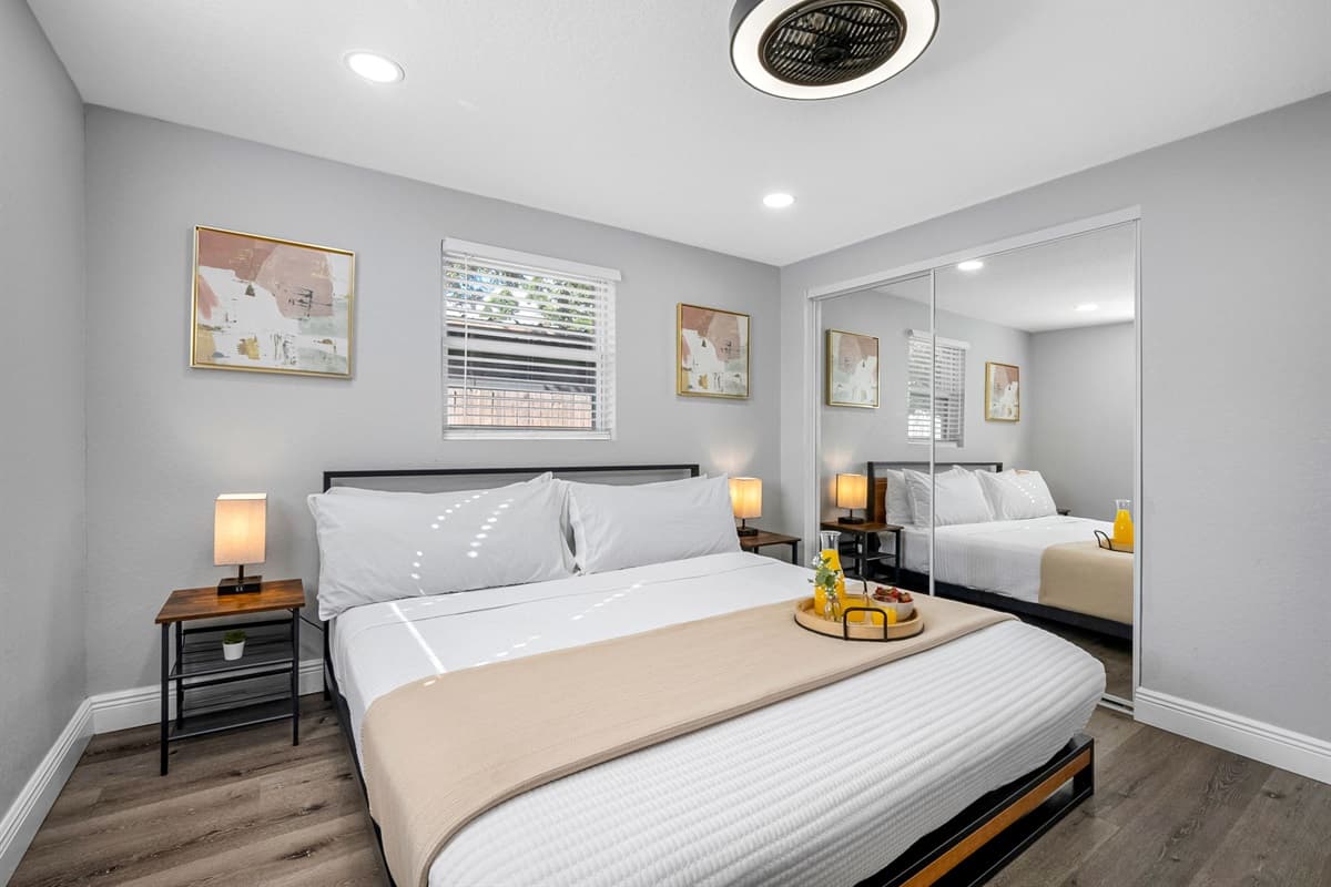 Featuring a sleek minimalist design, fresh linens, and bedside lighting that creates a relaxing evening ambiance.