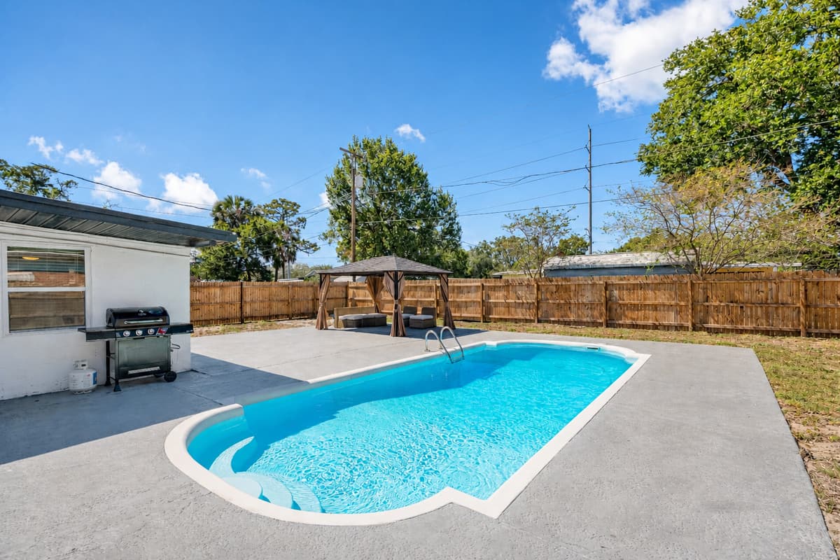 The crystal-clear waters of the pool invite you to take a refreshing dip, while the surrounding lounge chairs and sunbeds offer a front-row seat to the beauty of the outdoors.