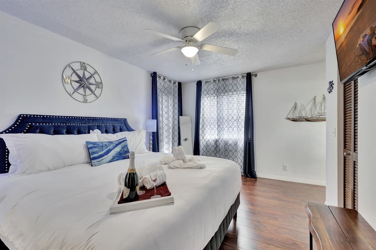 Beautiful wood flooring stretches across the bedroom, adding warmth and a sense of elegance to the space.