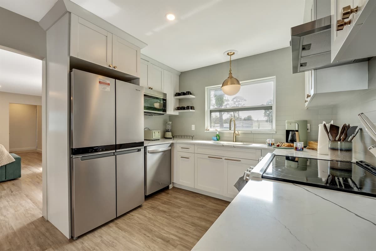 The kitchen welcomes you with its spacious layout, offering ample room for culinary endeavors and social gatherings alike.