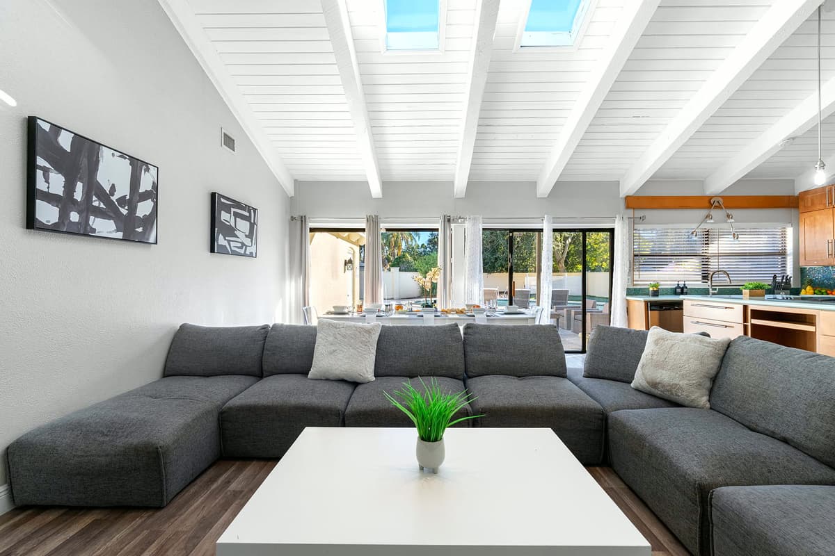 Bathe in natural light from the skylights and large sliding doors that open to the pool patio — indoor and outdoor living at its best.