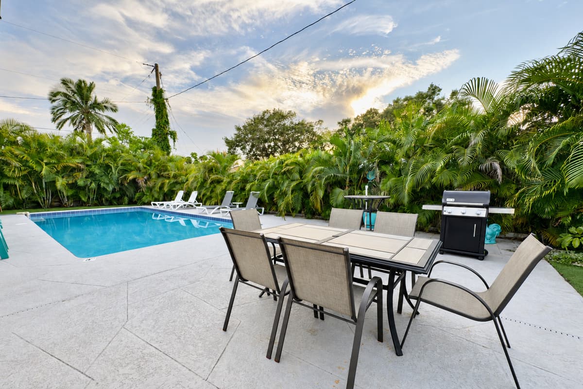 The outdoor patio includes a dining set for six, ideal for meals under the Florida sun or stars.