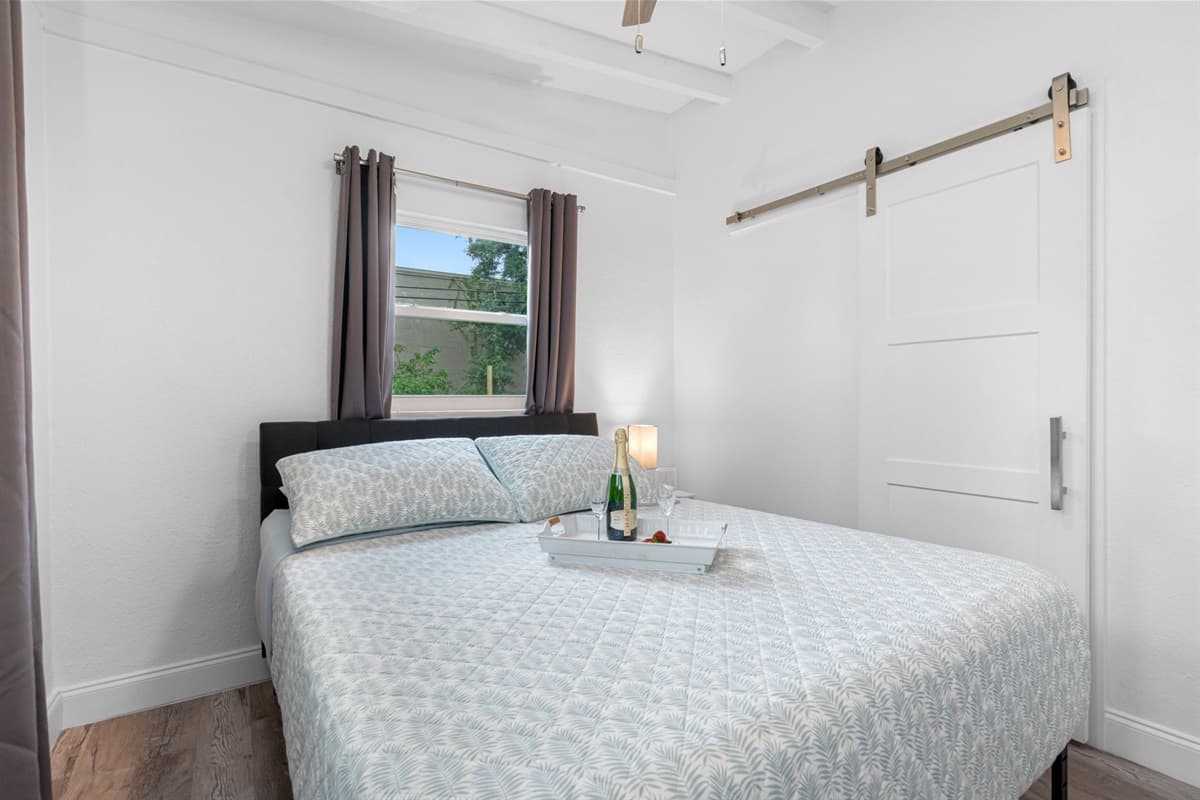 This charming bedroom features a plush queen-size bed adorned with high-quality linens and pillows.