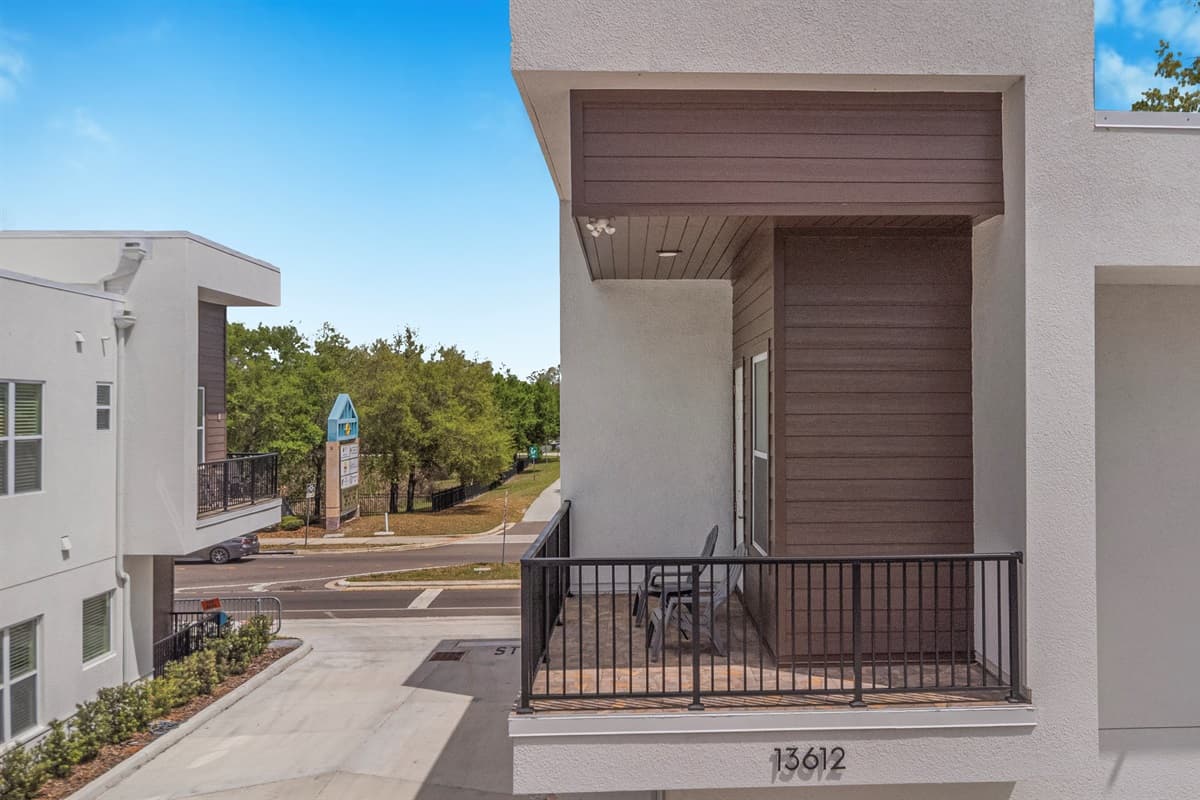 Your covered balcony overlooks a neighborhood park — perfect for morning coffee while watching the sunrise through the oaks.