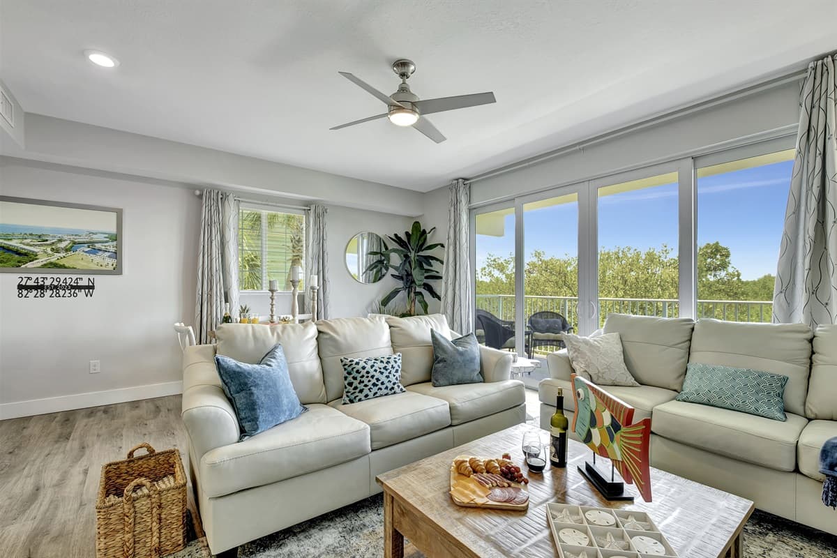 Bathed in the soft glow of natural light filtering through the open veranda doors, this space is a haven of tranquility and warmth.