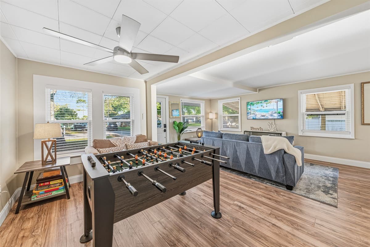 Spacious living area with foosball table and open layout—perfect for relaxing and entertaining.