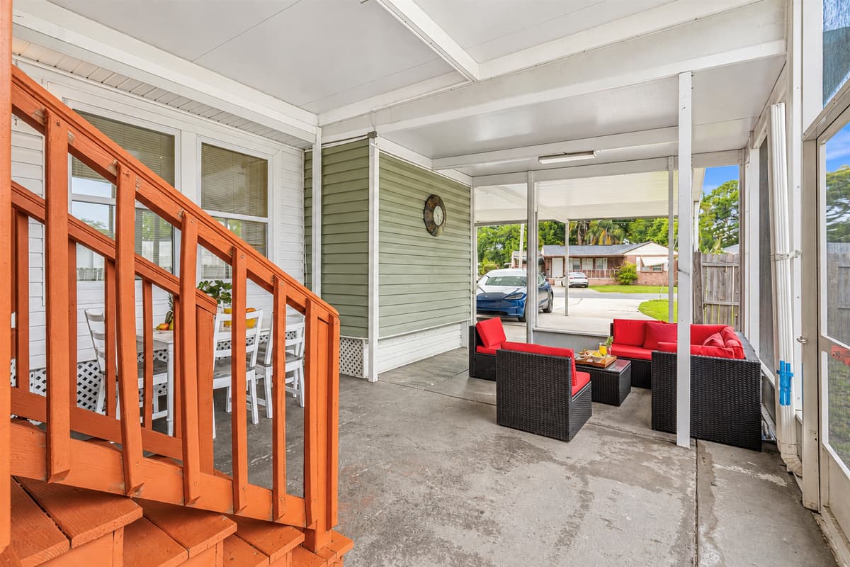 Covered patio with multiple seating areas—perfect for entertaining or unwinding.