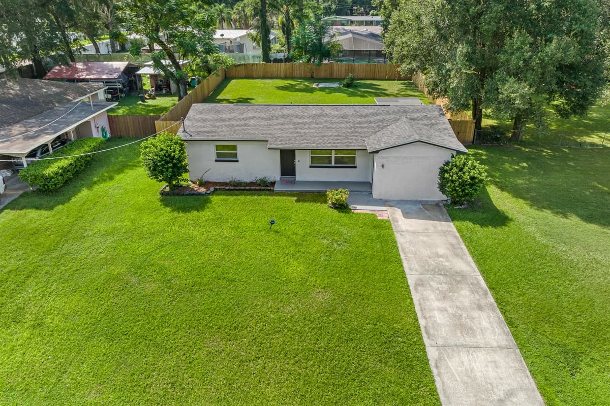 Breathtaking aerial front view of our eautiful property and the safe and wonderful neighborhood. Enjoy the view outside showcasing beautiful properties in the area. Book this property now!