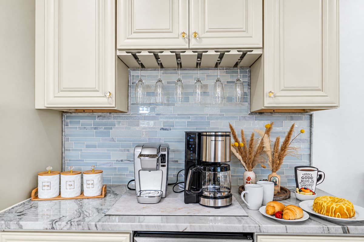 Enjoy a café-style experience right at home with this dedicated coffee station, complete with ample counter space and elegant finishes.