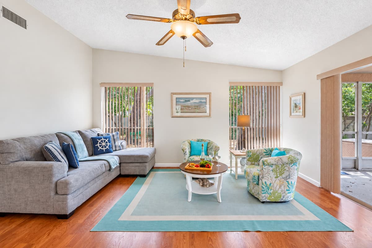 The second living room is thoughtfully designed to offer both style and comfort, featuring a chic L-shaped couch that serves as the room's centerpiece. 