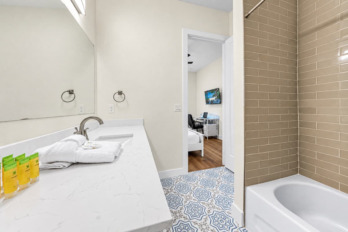 Clean, modern bathroom with spacious vanity and tub/shower combo.
