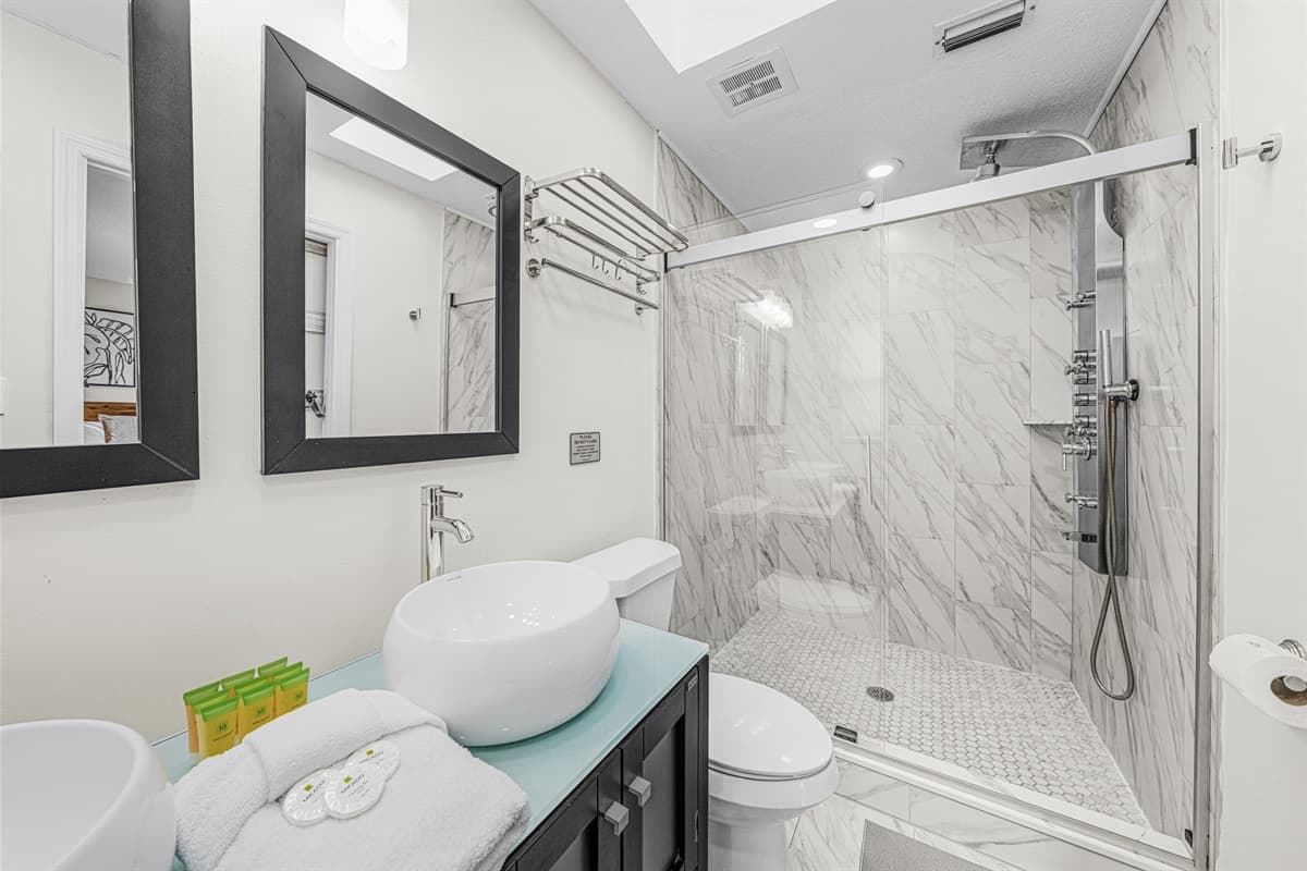 Spa-inspired bathroom featuring an oversized glass-enclosed walk-in shower.