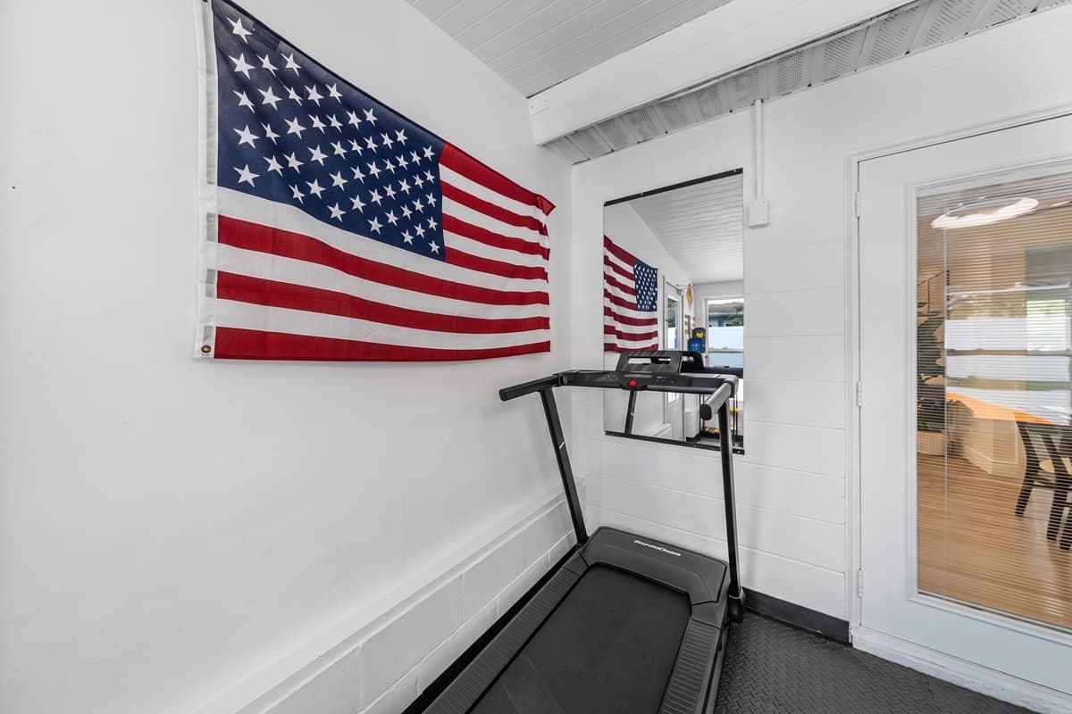 The bright, spacious gym features large mirrors and modern equipment to create an energizing workout environment.