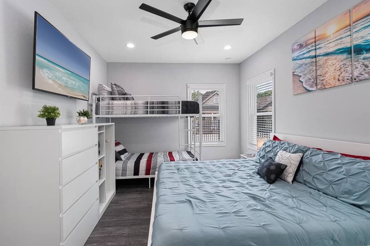 Beautiful bedroom with a bunkbed, king sized bed, drawers for storage and smart TV. Ideal room for a family with kids or a group of friends.