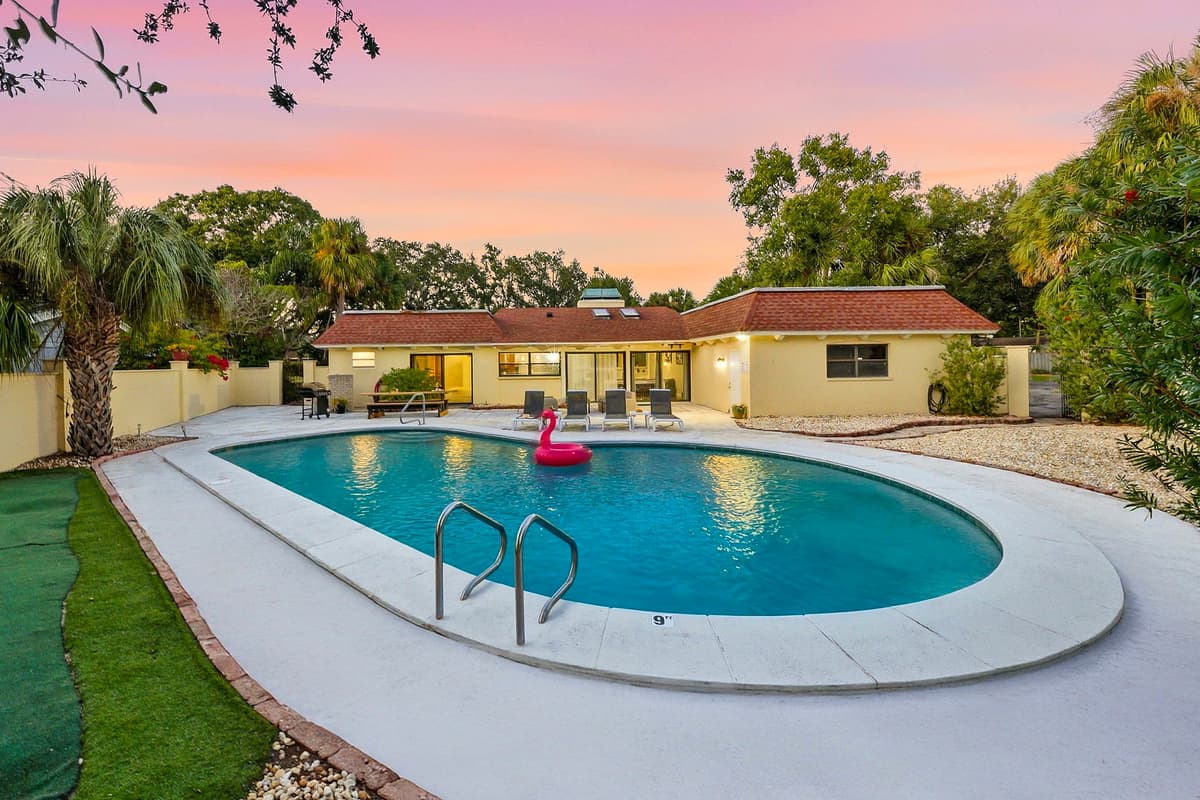 Surrounded by palm trees and tropical charm, this backyard oasis offers the perfect blend of relaxation and style.