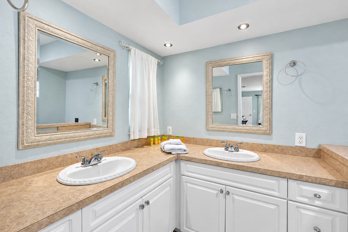 Featuring dual sinks, a glass-enclosed shower, and soft lighting for a relaxing start or end to your day.