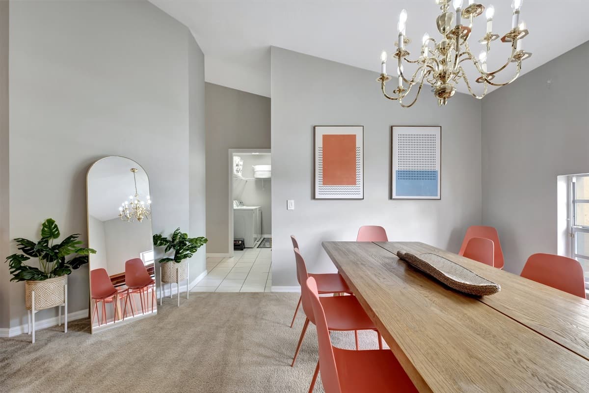 At the center of it all stands a magnificent wooden dining table, adorned with eight chairs, inviting you to gather and indulge in culinary delights.